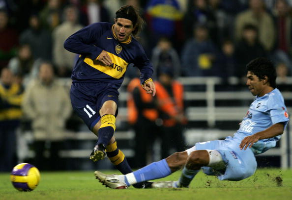 Bruno Marioni (L) of Boca Juniors scores
